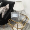 Designerski stolik kawowy o metalowym złotym stelarzu i geometrycznym kształcie